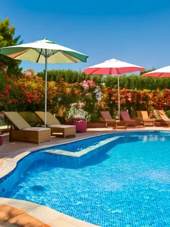 Swimming Pool surrounded by umbrellas and foliage
